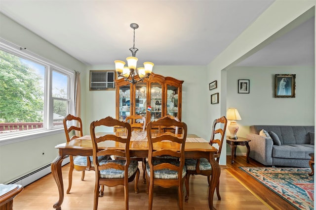 1A Ward St, Suffern, NY 10901 - dining space with a chandelier, light wood finished floors, a baseboard radiator, and a wall mounted AC