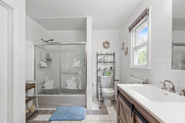 1A Ward St, Suffern, NY 10901 - full bath featuring vanity, combined bath / shower with glass door, toilet, and tile patterned floors