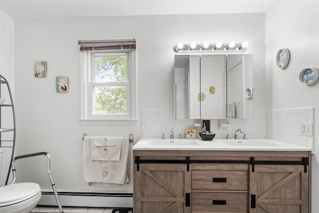 1A Ward St, Suffern, NY 10901 - bathroom featuring baseboard heating, double vanity, and toilet