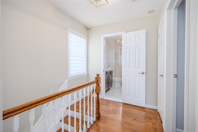 11 Spruce St, Garden City, NY 11530 - hall featuring an upstairs landing and light wood-style flooring