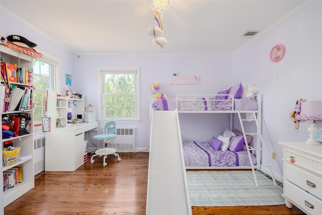 11 Spruce St, Garden City, NY 11530 - bedroom with radiator heating unit, ornamental molding, wood finished floors, and an office area