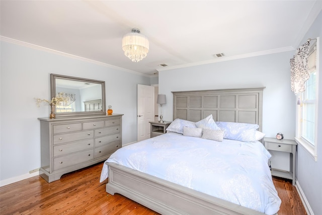 11 Spruce St, Garden City, NY 11530 - bedroom featuring wood finished floors, crown molding, and a chandelier