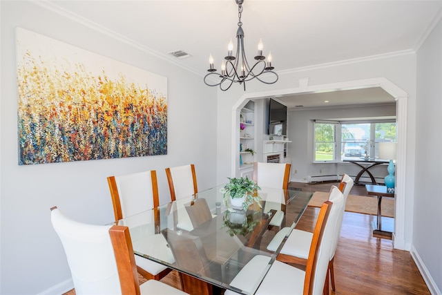 11 Spruce St, Garden City, NY 11530 - dining room with crown molding, a chandelier, wood finished floors, arched walkways, and baseboard heating