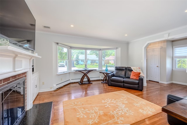 11 Spruce St, Garden City, NY 11530 - living room featuring a brick fireplace, wood finished floors, ornamental molding, arched walkways, and recessed lighting