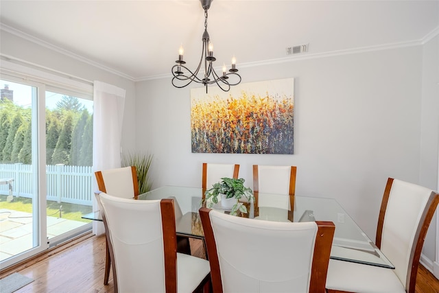 11 Spruce St, Garden City, NY 11530 - dining area with a chandelier, wood finished floors, and crown molding