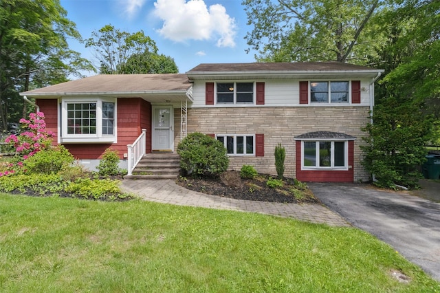 55 Stephanie Ln, Poughkeepsie, NY 12603 - split level home featuring a front lawn and stone siding