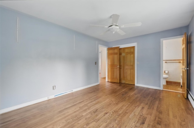 55 Stephanie Ln, Poughkeepsie, NY 12603 - unfurnished bedroom with wood finished floors, baseboards, a closet, ensuite bathroom, and ceiling fan