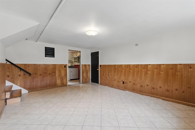 55 Stephanie Ln, Poughkeepsie, NY 12603 - unfurnished room with washer / clothes dryer, a wainscoted wall, wooden walls, and stairs