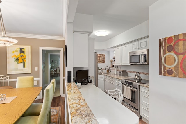50 Popham Rd Unit 4E, Scarsdale, NY 10583 - kitchen featuring appliances with stainless steel finishes, a sink, white cabinetry, ornamental molding, and dark wood-style flooring