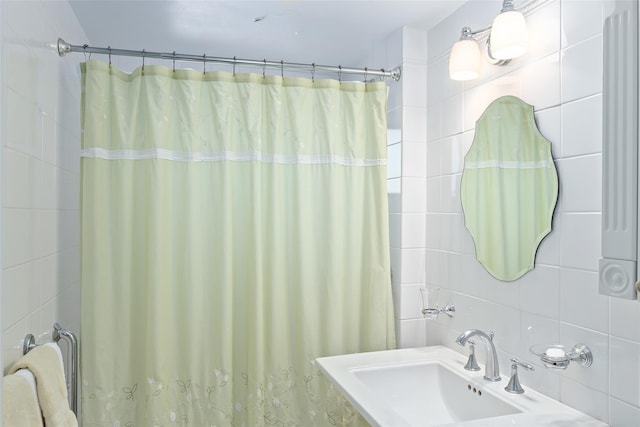 50 Popham Rd Unit 4E, Scarsdale, NY 10583 - full bathroom with a sink, a shower with shower curtain, tile walls, and radiator heating unit