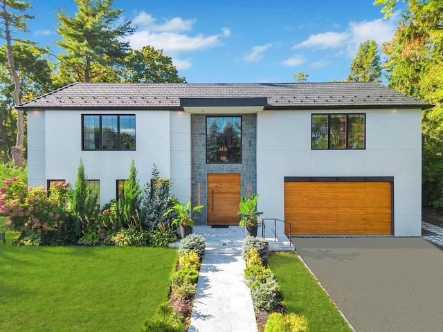 50 Gristmill Ln, Great Neck, NY 11023 - contemporary home with stucco siding, a garage, asphalt driveway, a front lawn, and a high end roof