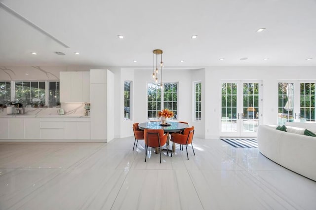 50 Gristmill Ln, Great Neck, NY 11023 - dining room featuring french doors, light tile patterned floors, and recessed lighting