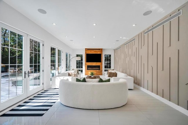 50 Gristmill Ln, Great Neck, NY 11023 - living area featuring french doors, a lit fireplace, and recessed lighting