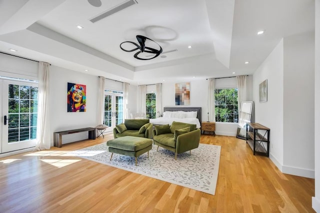 50 Gristmill Ln, Great Neck, NY 11023 - living room featuring a ceiling fan, a raised ceiling, light wood-style flooring, french doors, and recessed lighting