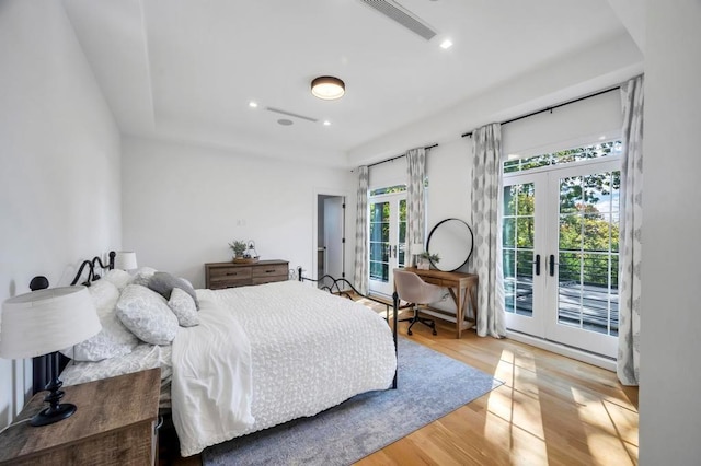 50 Gristmill Ln, Great Neck, NY 11023 - bedroom featuring french doors, access to exterior, wood finished floors, and recessed lighting