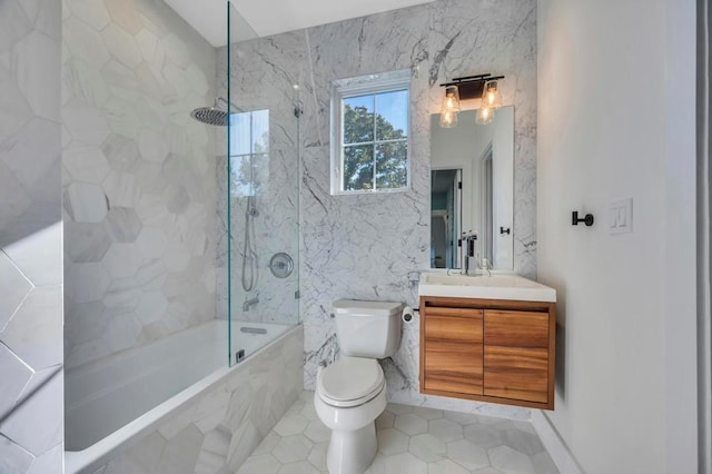 50 Gristmill Ln, Great Neck, NY 11023 - bathroom with tile patterned flooring, vanity, tile walls, toilet, and a combined bath / shower with marble appearance