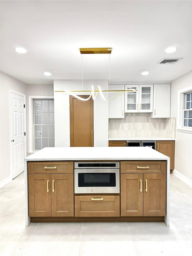 56 Patmore Ave, Yonkers, NY 10710 - kitchen featuring stainless steel oven, white cabinetry, tasteful backsplash, baseboards, and recessed lighting