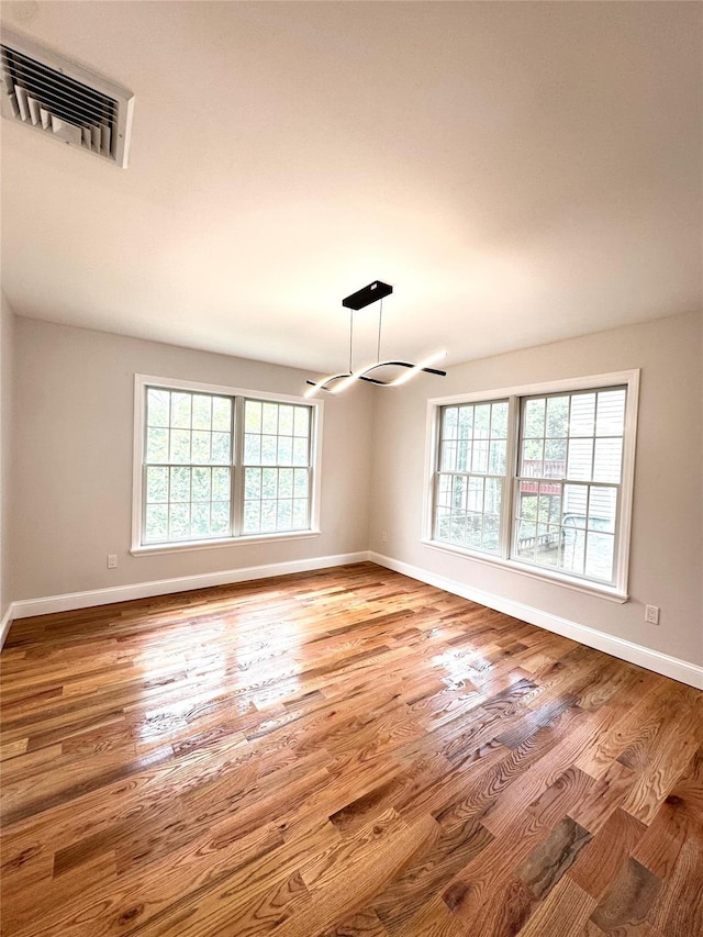 56 Patmore Ave, Yonkers, NY 10710 - spare room with baseboards, wood finished floors, and a chandelier