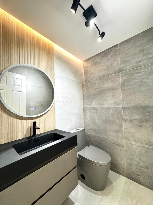 56 Patmore Ave, Yonkers, NY 10710 - bathroom with vanity, toilet, and tile walls