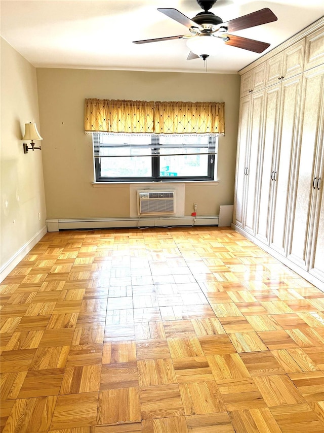 1 Overlook Ave Unit 1L, Great Neck, NY 11021 - spare room featuring ceiling fan, baseboards, and a wall unit AC