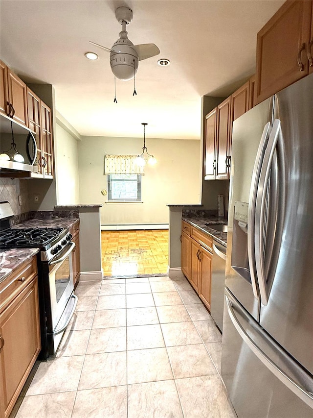 1 Overlook Ave Unit 1L, Great Neck, NY 11021 - kitchen featuring appliances with stainless steel finishes, baseboard heating, ceiling fan, light tile patterned floors, and brown cabinetry
