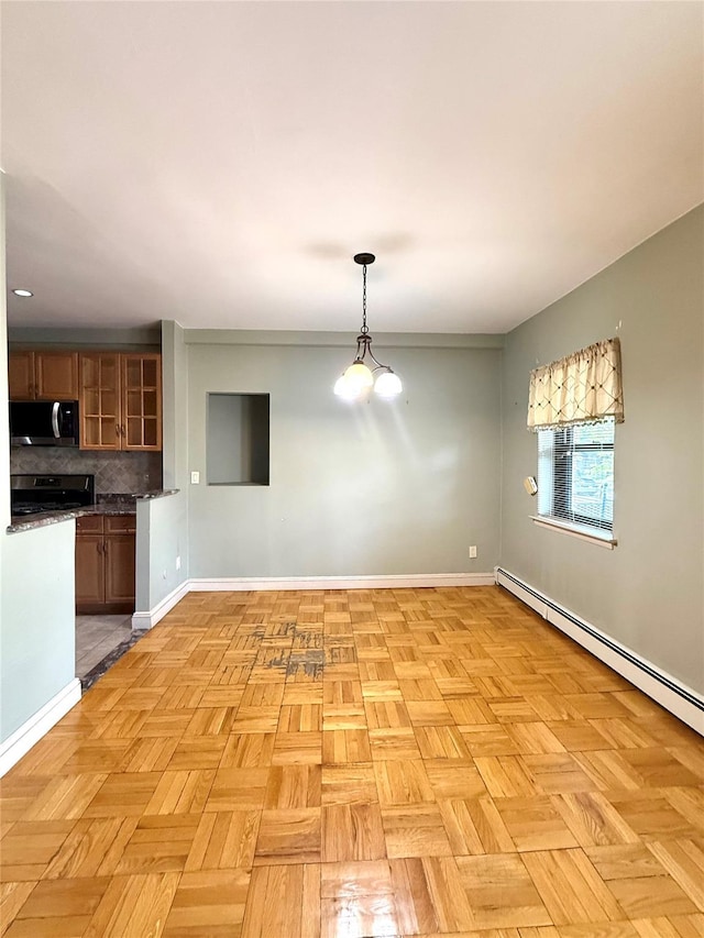 1 Overlook Ave Unit 1L, Great Neck, NY 11021 - unfurnished dining area featuring baseboards and a baseboard radiator