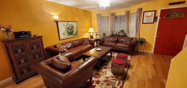 8439 130th St, Kew Gardens, NY 11415 - living area with wood finished floors, a chandelier, and baseboards