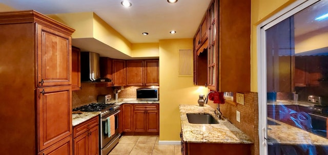 8439 130th St, Kew Gardens, NY 11415 - kitchen featuring wall chimney range hood, appliances with stainless steel finishes, a sink, decorative backsplash, and light stone counters