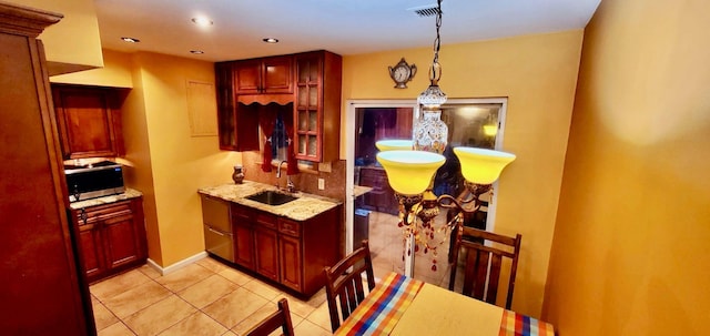 8439 130th St, Kew Gardens, NY 11415 - kitchen featuring a sink, stainless steel microwave, dark brown cabinets, light tile patterned floors, and recessed lighting