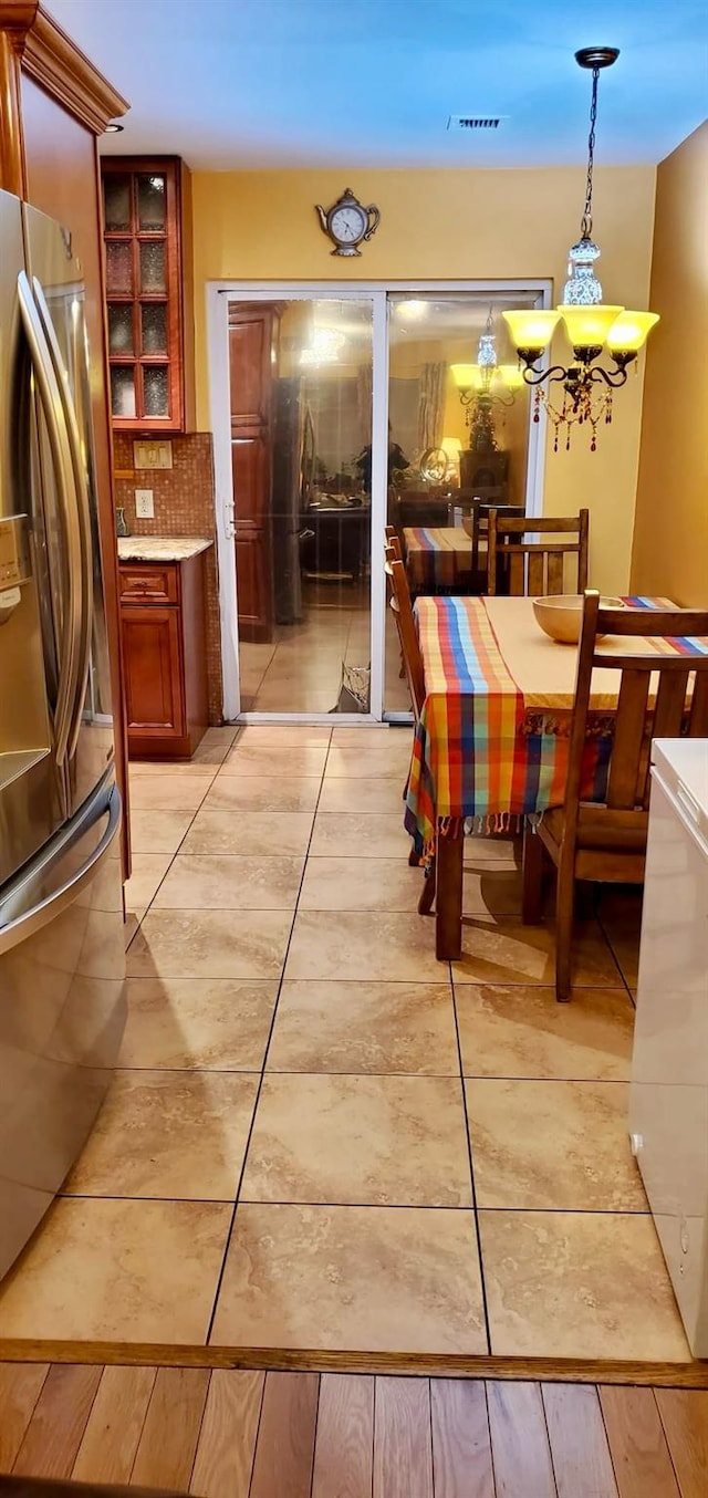 8439 130th St, Kew Gardens, NY 11415 - dining room featuring light tile patterned floors and a chandelier