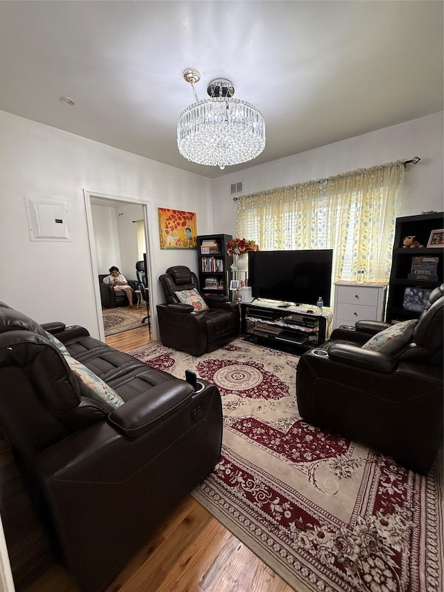 10808 86th St, Ozone Park, NY 11417 - living area with wood finished floors and a chandelier