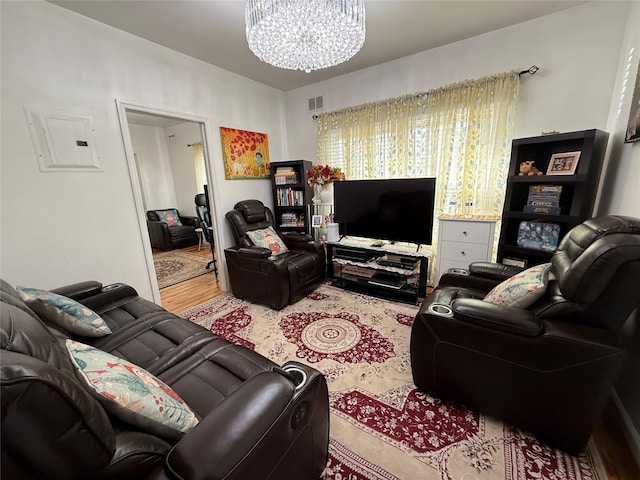 10808 86th St, Ozone Park, NY 11417 - living area with a chandelier, wood finished floors, and electric panel