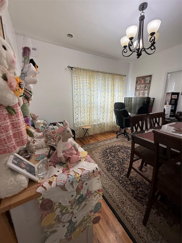 10808 86th St, Ozone Park, NY 11417 - dining area with wood finished floors, a chandelier, and an office area