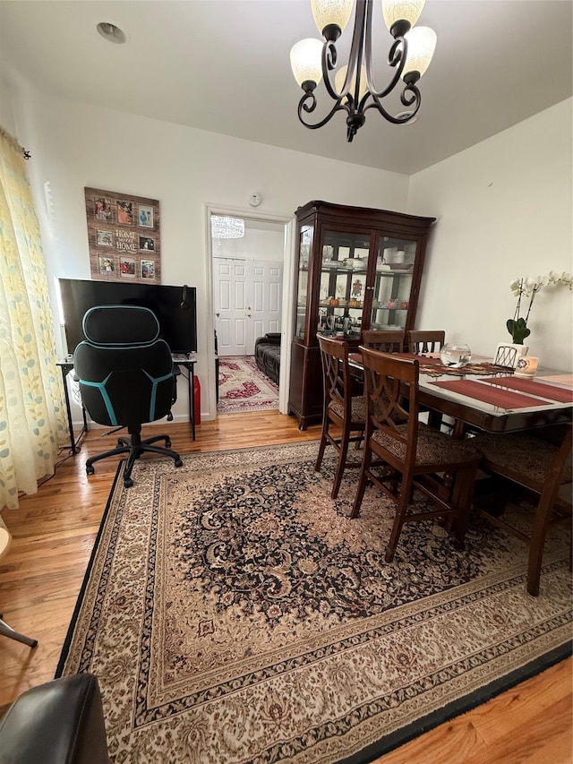 10808 86th St, Ozone Park, NY 11417 - dining space with a chandelier, wood finished floors, and a desk