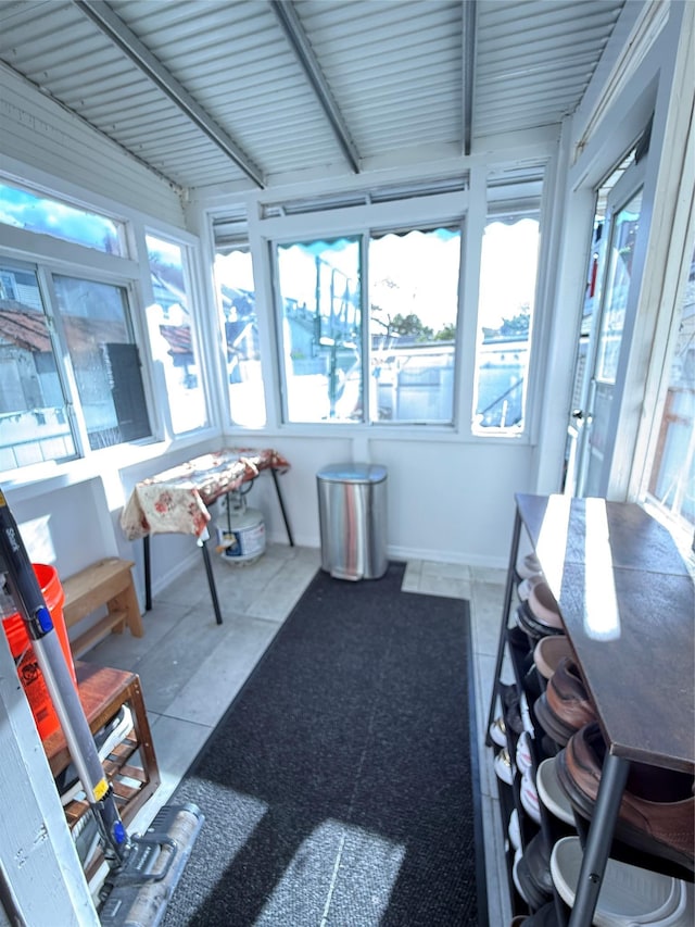 10808 86th St, Ozone Park, NY 11417 - sunroom with plenty of natural light, tile patterned floors, and baseboards