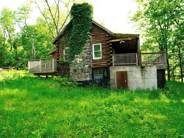 68 Union School Rd, Montgomery, NY 12549 - back of property with a chimney, log siding, a deck, and stone siding