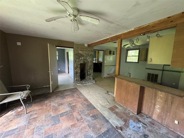 68 Union School Rd, Montgomery, NY 12549 - unfurnished living room featuring ceiling fan, a stone fireplace, and stone finish floors
