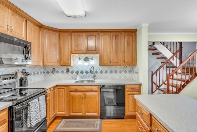2103 Kings Way Unit 2103, Carmel, NY 10512 - kitchen featuring black appliances, a sink, decorative backsplash, light countertops, and crown molding