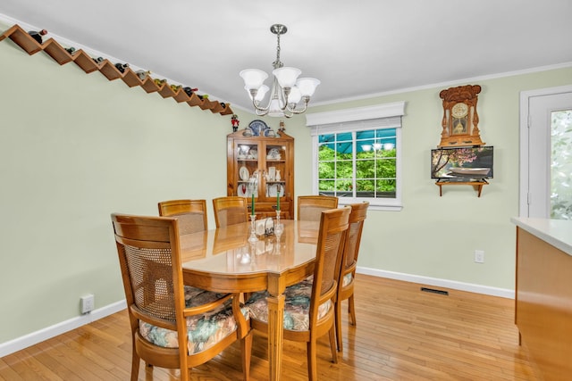 2103 Kings Way Unit 2103, Carmel, NY 10512 - dining room with a chandelier, light wood-style flooring, crown molding, and baseboards