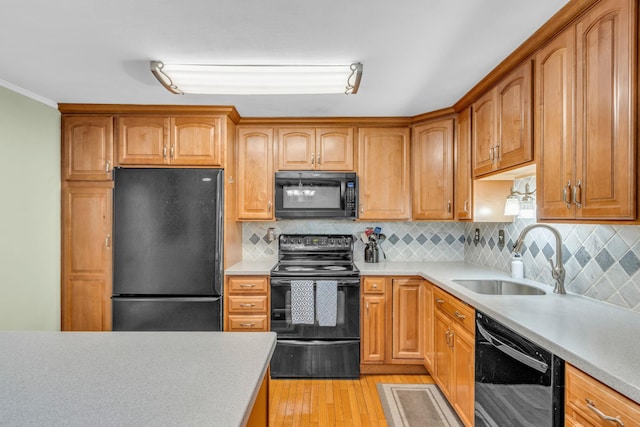 2103 Kings Way Unit 2103, Carmel, NY 10512 - kitchen with black appliances, a sink, light countertops, light wood finished floors, and ornamental molding