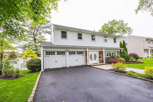 8 Marietta Dr, Westbury, NY 11590 - view of front facade with a garage, driveway, and brick siding