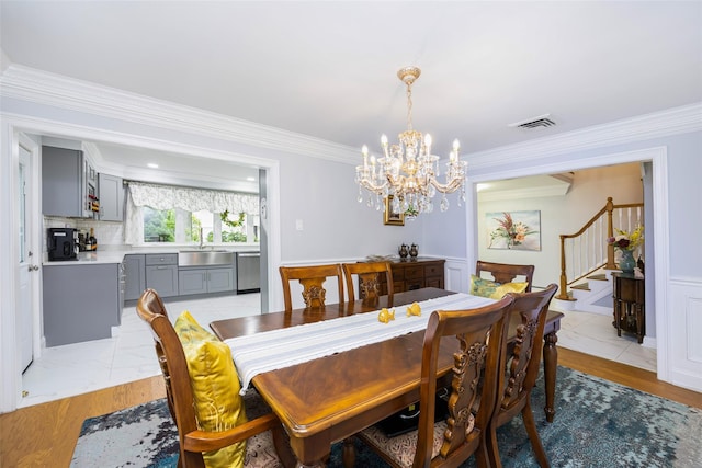 8 Marietta Dr, Westbury, NY 11590 - dining room with stairs, a chandelier, crown molding, and light wood finished floors