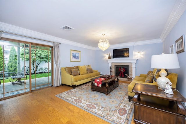 8 Marietta Dr, Westbury, NY 11590 - living area featuring wood finished floors, a chandelier, ornamental molding, and a fireplace
