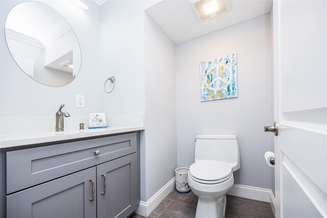 8 Marietta Dr, Westbury, NY 11590 - half bath featuring vanity, baseboards, toilet, and wood finished floors