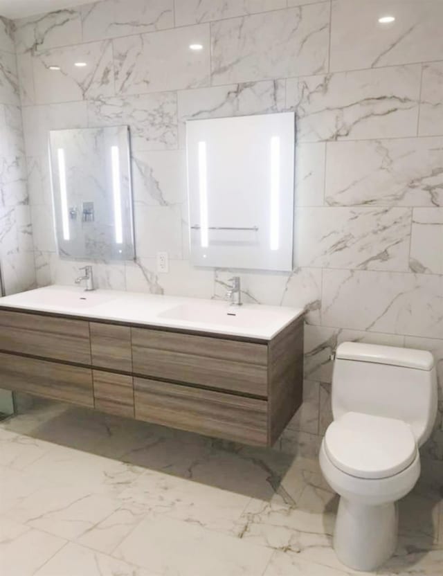 13101 40th Rd Unit 10C, Flushing, NY 11354 - bathroom with double vanity, tile walls, toilet, and marble finish floors