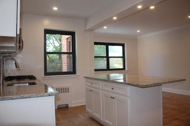 51 White Oak Unit 1H, New Rochelle, NY 10801 - kitchen featuring radiator heating unit, a sink, healthy amount of natural light, white cabinetry, and recessed lighting