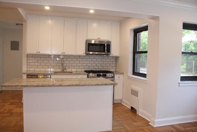 51 White Oak Unit 1H, New Rochelle, NY 10801 - kitchen with appliances with stainless steel finishes, a sink, radiator, white cabinets, and ornamental molding