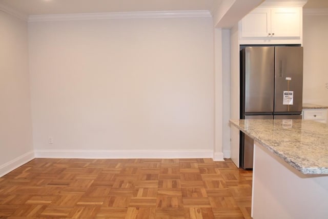 51 White Oak Unit 1H, New Rochelle, NY 10801 - kitchen featuring white cabinets, freestanding refrigerator, baseboards, light stone countertops, and ornamental molding