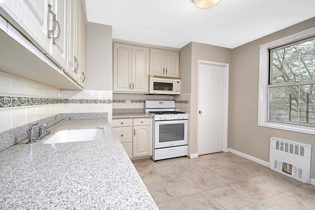 609 Kappock St Unit 3F, Bronx, NY 10463 - kitchen with white appliances, radiator heating unit, a sink, tasteful backsplash, and baseboards