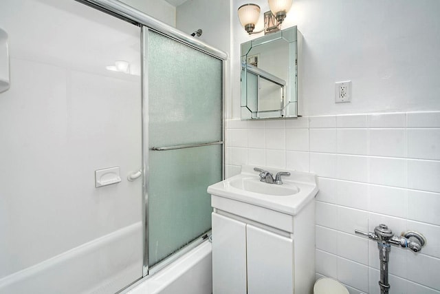 609 Kappock St Unit 3F, Bronx, NY 10463 - bathroom featuring tile walls, bath / shower combo with glass door, and vanity